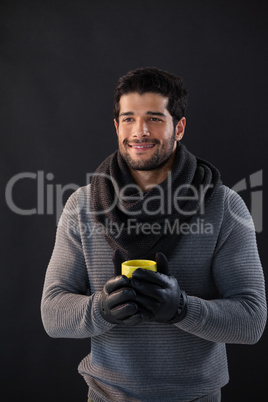 Smiling man holding a mug of coffee