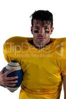 Portrait of American football player holding ball