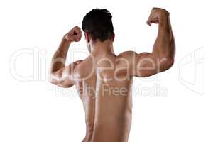 Rear view of sportsman flexing muscles