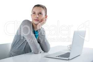 Teenage girl sitting against white background