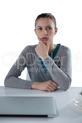 Teenage girl sitting against white background