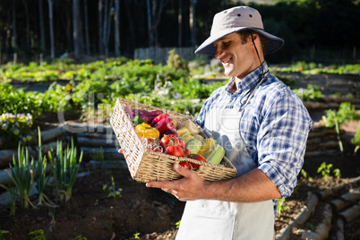 Happy man holding a basket of fresh vegetables