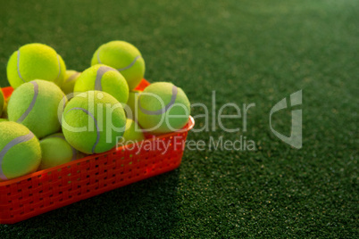 Close up of tennis balls in plastic container