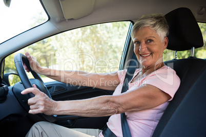 Active senior woman driving a car