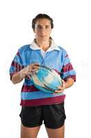 Portrait of confident female player with rugby ball