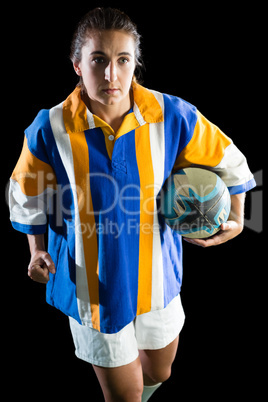 Young female athlete playing rugby