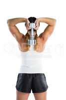 Rear view of female athlete holding dumbbell