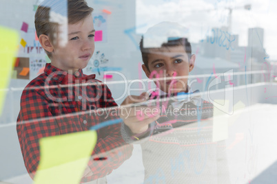 Kids as business executives discussing over whiteboard