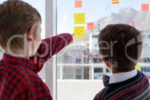 Kids as business executives discussing over whiteboard