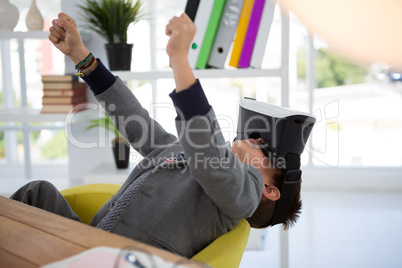 Boy as business executive using virtual reality headset