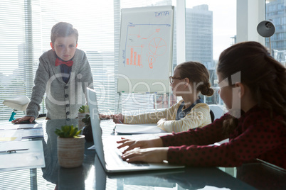 Kids as business executives interacting while meeting