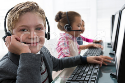 Boy as customer care executive smiling while working in the office
