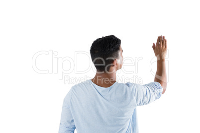 Man pretending to touch an invisible screen against white background