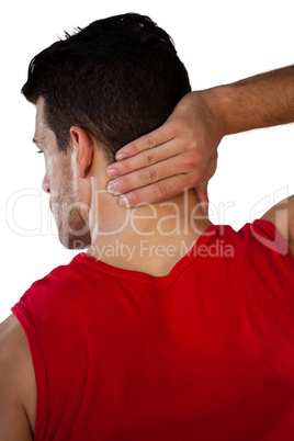 Rear view of sports player suffering from neck pain