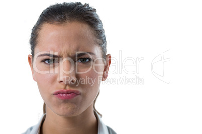 Confused female executive against white background