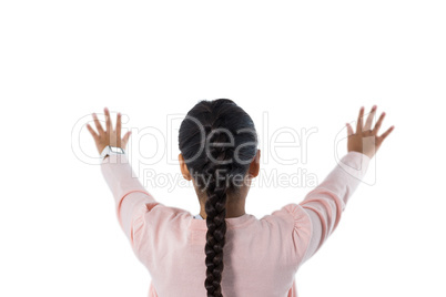 Girl pretending to touch an invisible screen against white background