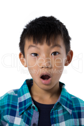 Astonished  boy standing against white background