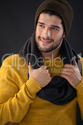 Smiling man holding scarf