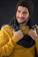 Smiling man holding scarf