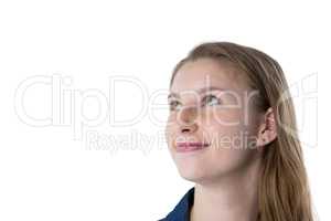 Thoughtful teenage girl smiling against white background