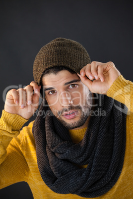 Man posing against black background