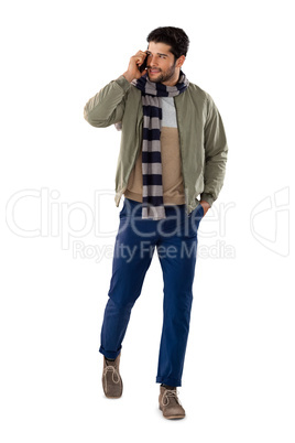 Man talking on mobile phone against white background