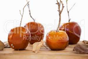 Apples and autumn leaves on wooden table