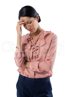 Tensed female executive standing against white background