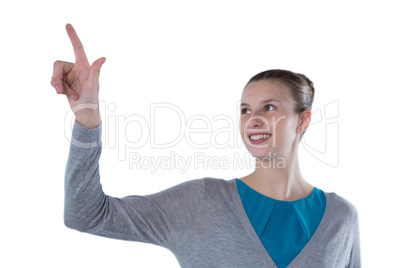 Smiling teenage girl pressing an invisible virtual screen