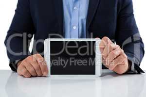Businessman showing digital tablet against white background
