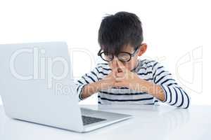 Boy using laptop against white background