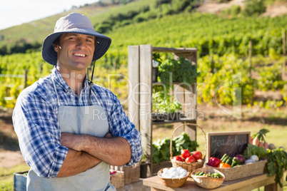 Portrait of farmer standing with arms crossed