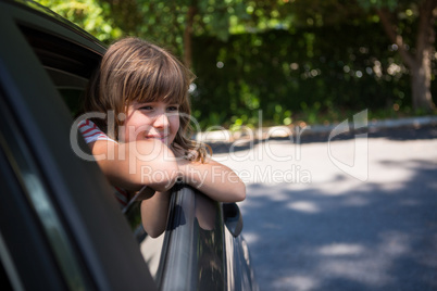 Teenage girl looking through car window