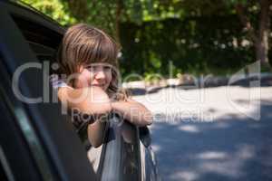 Teenage girl looking through car window