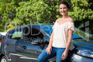 Beautiful woman leaning on a car