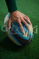 Cropped image of hand holding rugby ball