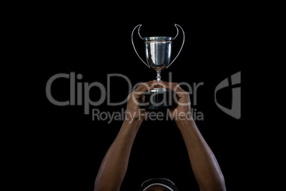 Cropped hand on sportsperson holding trophy