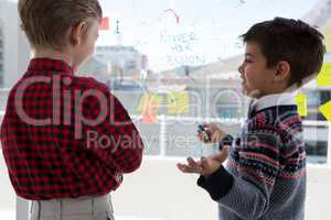 Kids as business executives discussing over whiteboard