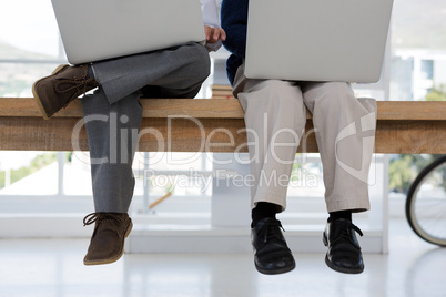 Kids as business executives using laptop in office