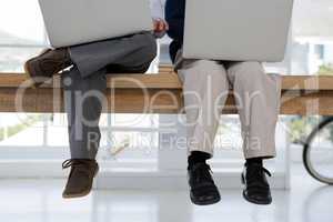 Kids as business executives using laptop in office