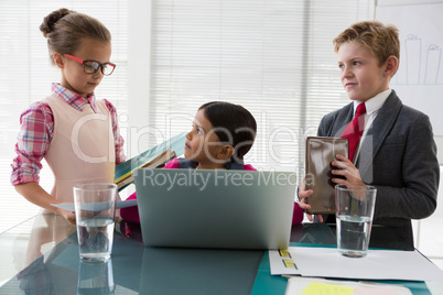 Kids as business executives interacting while meeting