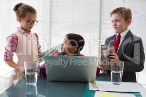 Kids as business executives interacting while meeting