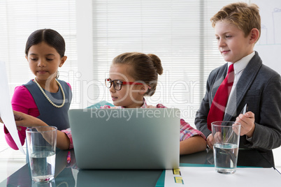 Kids as business executives interacting while meeting