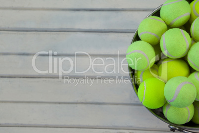 Directly above view of tennis balls in metallic bucket