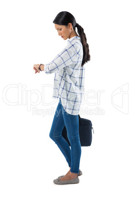 Female executive with briefcase looking at her wristwatch