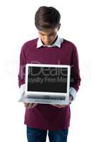 Teenage boy showing a laptop