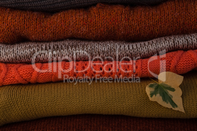 Woolen stack with autumn leaves