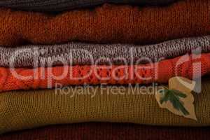 Woolen stack with autumn leaves