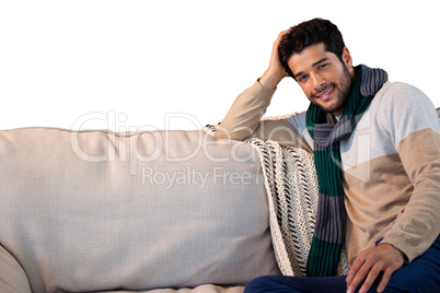 Portrait of smiling man relaxing on sofa