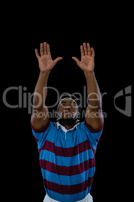 Sportsman with arms raised playing rugby